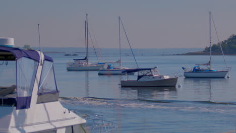 dingly traveling through shot surrounded by boats on a sunny day in new york with blue sky