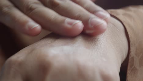 applying lotion on wrist