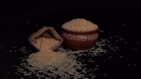 uncooked white rice on wooden desk, white uncooked rice in a small sack bag