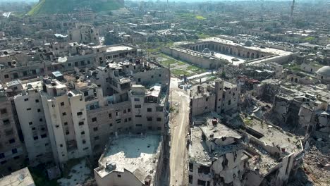 aerial view over ruined muslim mosque in aleppo, under blue sky. buildings of the city of aleppo are ruined after bombing in the civil war in syria.