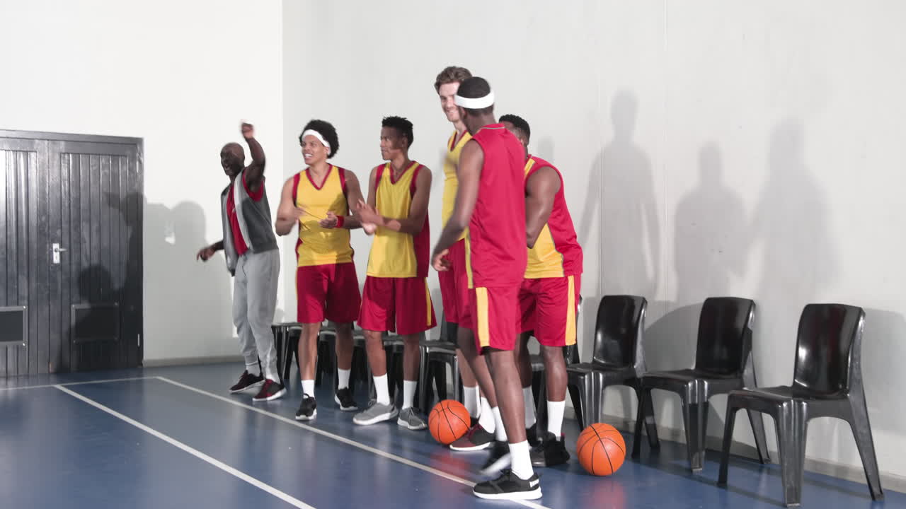 Basketball team celebrating victory on court, smiling and cheering together