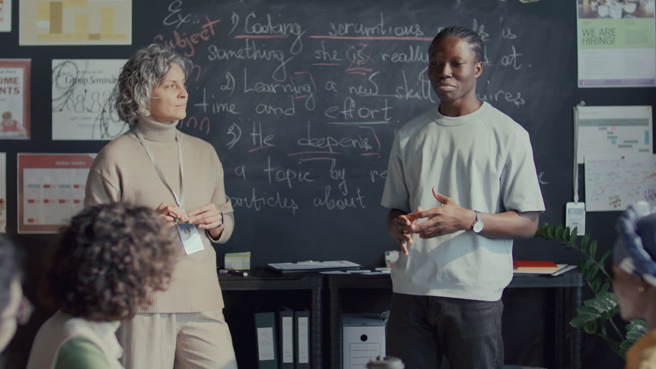 Black Student Answering Questions in front of Teacher and Peers in English Class