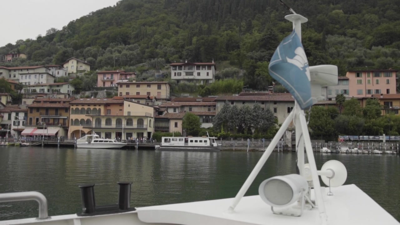 Barca che arriva a un molo su un lago italiano