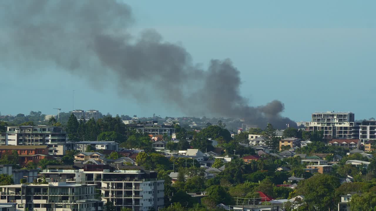 Police declare a structure fire at a commercial premises on Boothby Street, Kedron, a crime scene after confirming arson, time-lapse shot showing thick black smoke billowing into the air.
