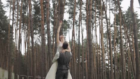 lovely newlyweds caucasian bride groom dancing in park, making kiss, wedding couple family