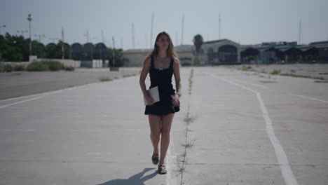 woman walking with tablet on a street