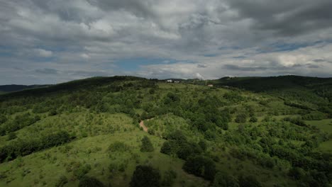Aerial-Earth-World,-green-woodland-land-drone-view,-turkish-mountain-range-view,-high-green-fields-under-clouds-and-sky