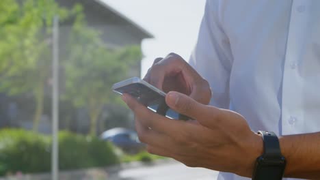 Man-using-mobile-phone-in-street-side-4k