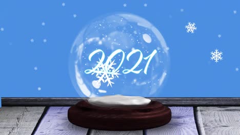 Animation-of-2021-in-snow-globe-on-wooden-boards,-shooting-star-and-snow-falling