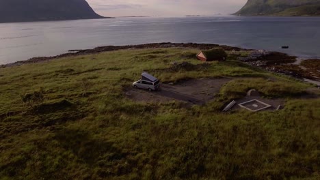 aerial of a camping car near a fjord on lofoten, norway