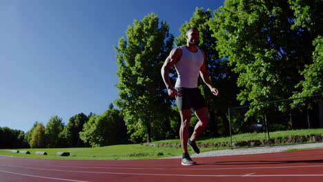 man running on a track in an outdoor setting