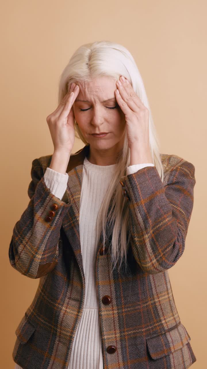 Woman Suffering from Headache and Stress Rubbing Temples
