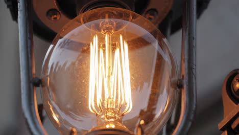 close-up of an edison light bulb turning on and off