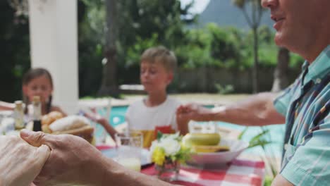 happy family eating together at table