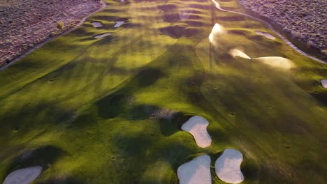 sunset irrigation over a golf course in the desert