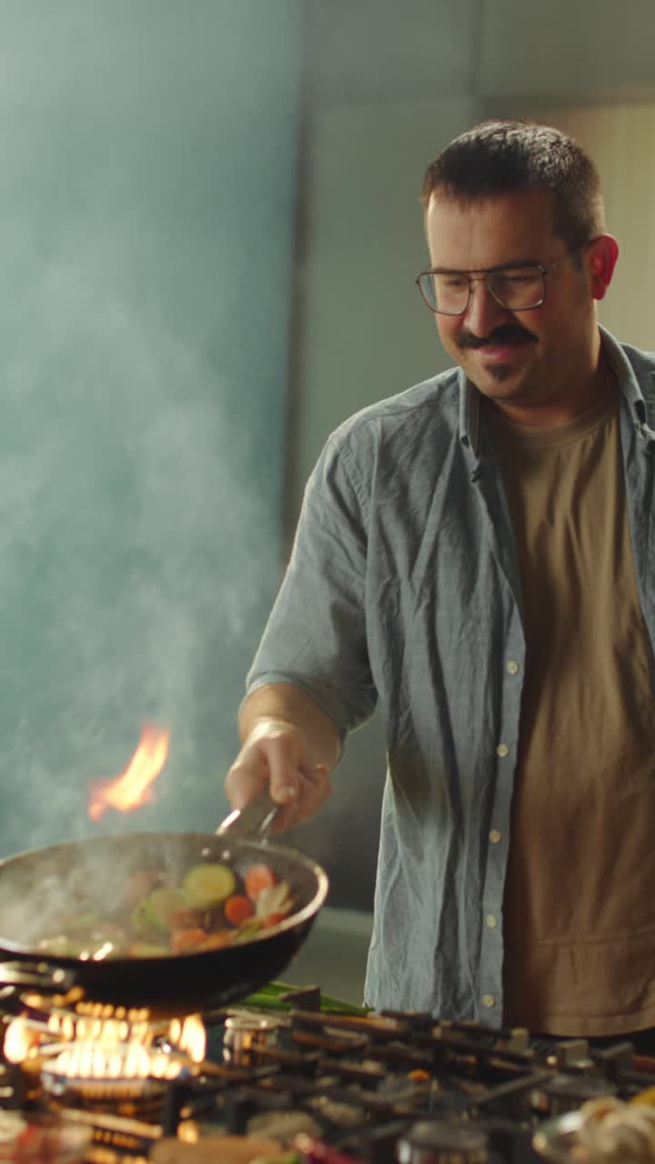 Man Cooking with Fire in Kitchen
