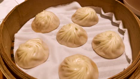 chinese style restaurant, famous shanghai cuisine, fresh hot xiao long bao in streamer