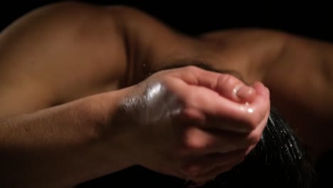 hand of woman pour clean water on wet hair to clean, the back of the young lady in the background