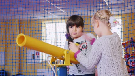 children play with an air gun in the entertainment center