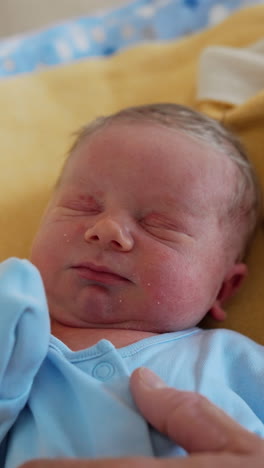 small newborn portrait. adorable young boy lies on the bed. vertical video