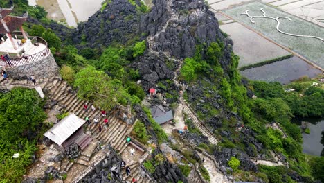 Aerial-Overhead-View-Of-Visitors-Walking-Down-Hang-Mua-Steps