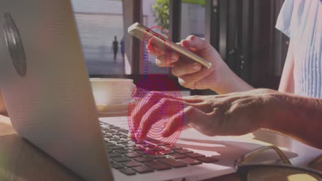 Animation-of-padlock-icon-and-data-processing-over-caucasian-woman-using-laptop-and-smartphone