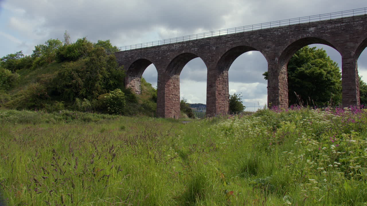 Wide shot of The North Water Viaduct, disused railway viaduct with car, on the north river esk. next to the A92