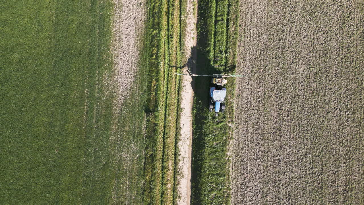 Tractor driving through fields of Spain, aerial view