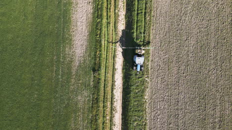 Tractor driving through fields of Spain, aerial view