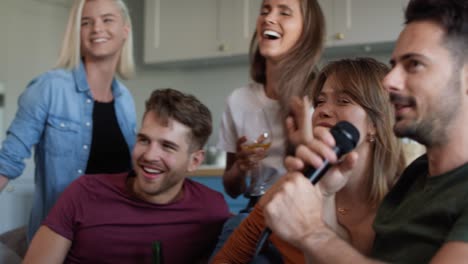 group of friends singing at home karaoke