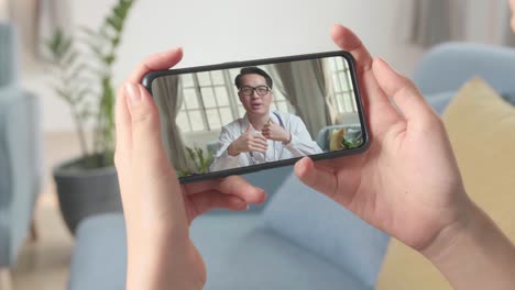 close up of a person video conferencing with doctor on smartphone, video in 4k