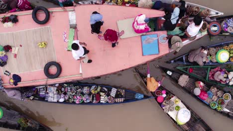 Floating-market-with-local-Indonesian-people-trading-fresh-food,-aerial