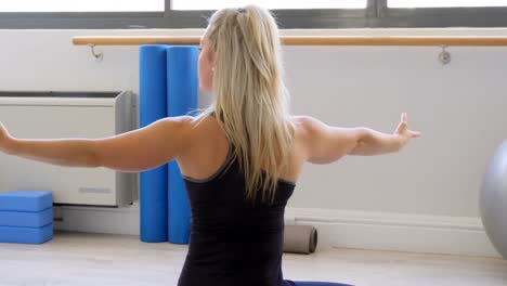 woman doing yoga in fitness gym 4k