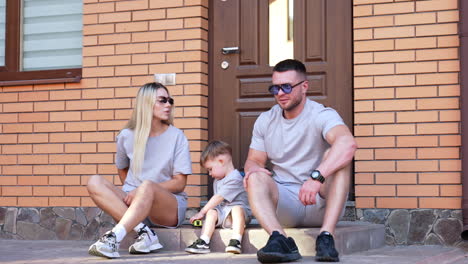 family has fun on a sunny day. a smiling family plays together on the porch while sharing moments of joy and laughter in warm weather