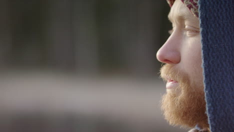 pan reveal cu of a handsome bearded ice bather conscious breathing before going in