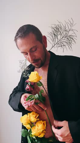 man in black suit with flowers