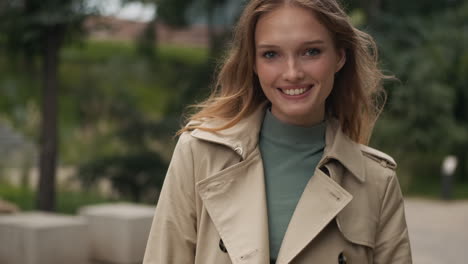 Caucasian-woman-looking-at-the-camera-and-smiling-outdoors.