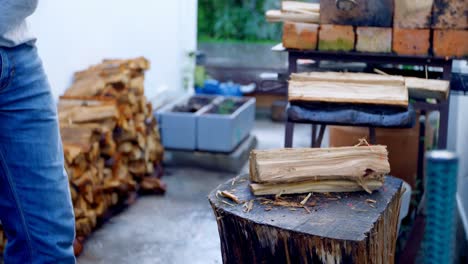 male lumberjack chopping wooden logs with axe 4k