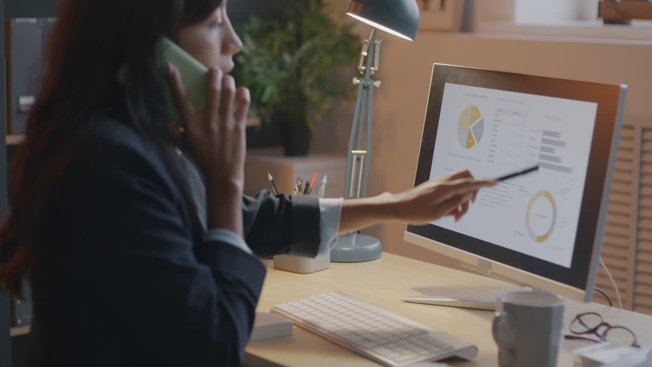 Business Woman on Phone Discussing Data Charts