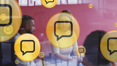 Animation of media icons over diverse business people during meeting