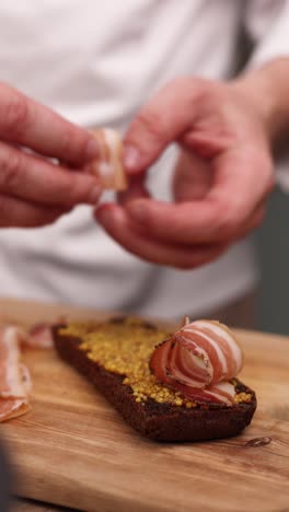 chef preparing a bacon and mustard sandwich