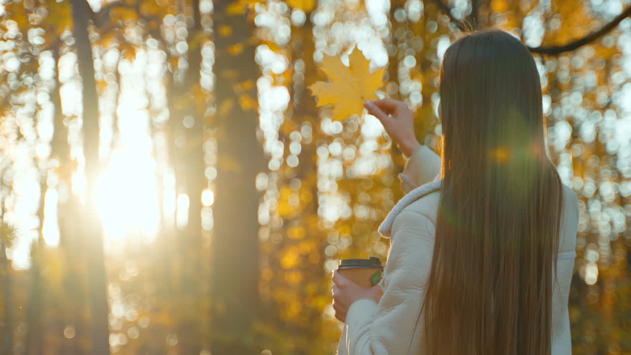 Woman enjoying a coffee in an autumn forest