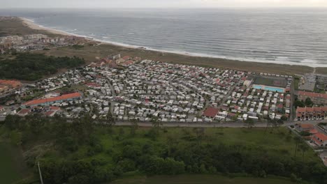 aerial view of an caravan park with a yellow beach near