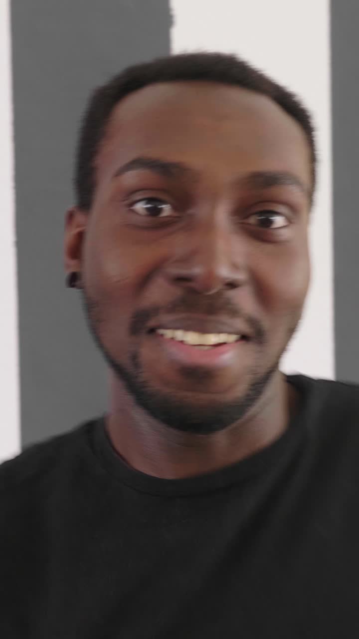 Close-up portrait of a smiling young black man