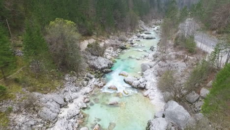 aerial - flying low above the turquoise color river