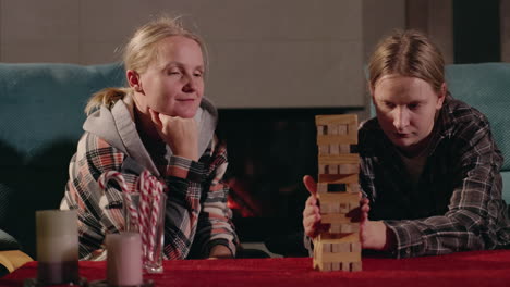 mother and daughter playing jenga