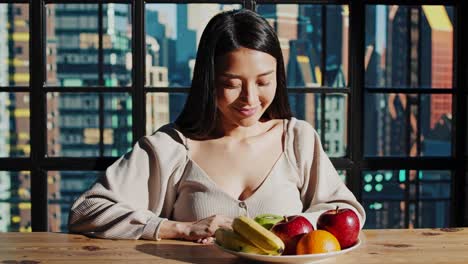 woman enjoying a healthy fruit plate in an urban setting