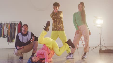 Portrait-of-happy-diverse-male-and-female-dancers-posing-in-dance-studio,-slow-motion