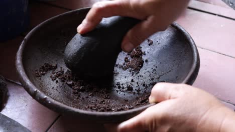 close up hand is making indonesian herbs and spices