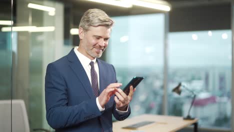 mature business man hold smartphone satisfied read message, results financial report makes transactions, purchases, shopping, payments
